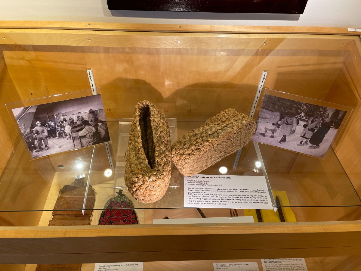 Display case with old photos and historic Swedish footwear at the Swedish Heritage in BC Museum