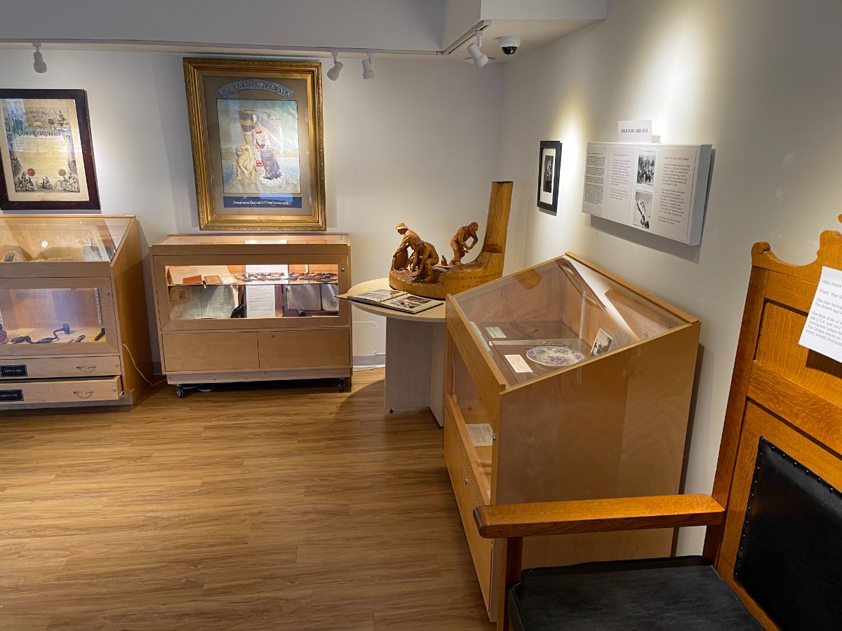 Display cases and antique lodge chair at the Swedish Heritage in BC