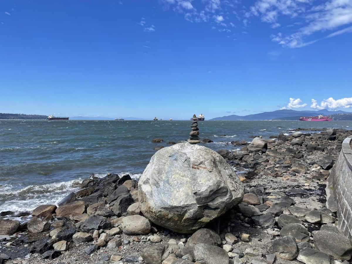 inukshuk rock sculpture on the stanley park seawall in vancouver