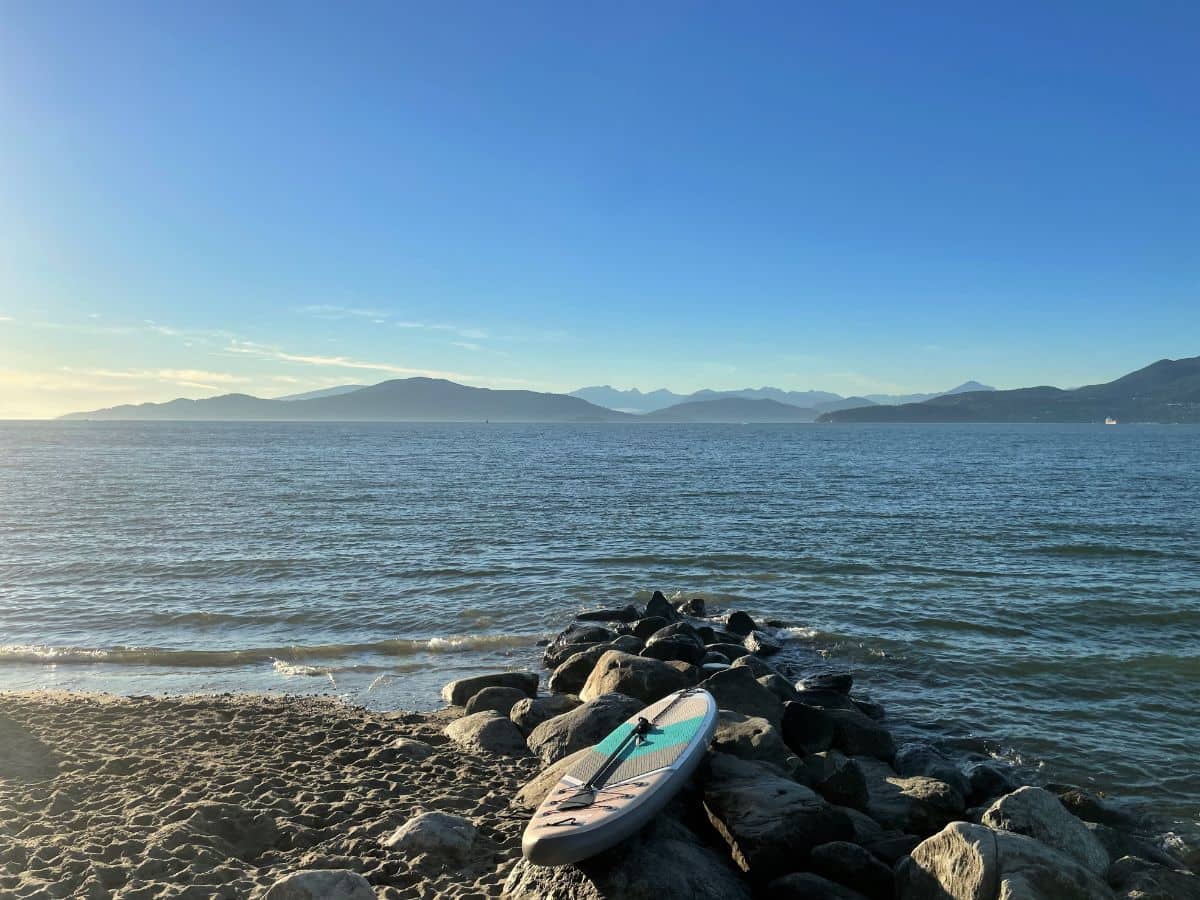 paddle board on the shores of spanish banks at sunset