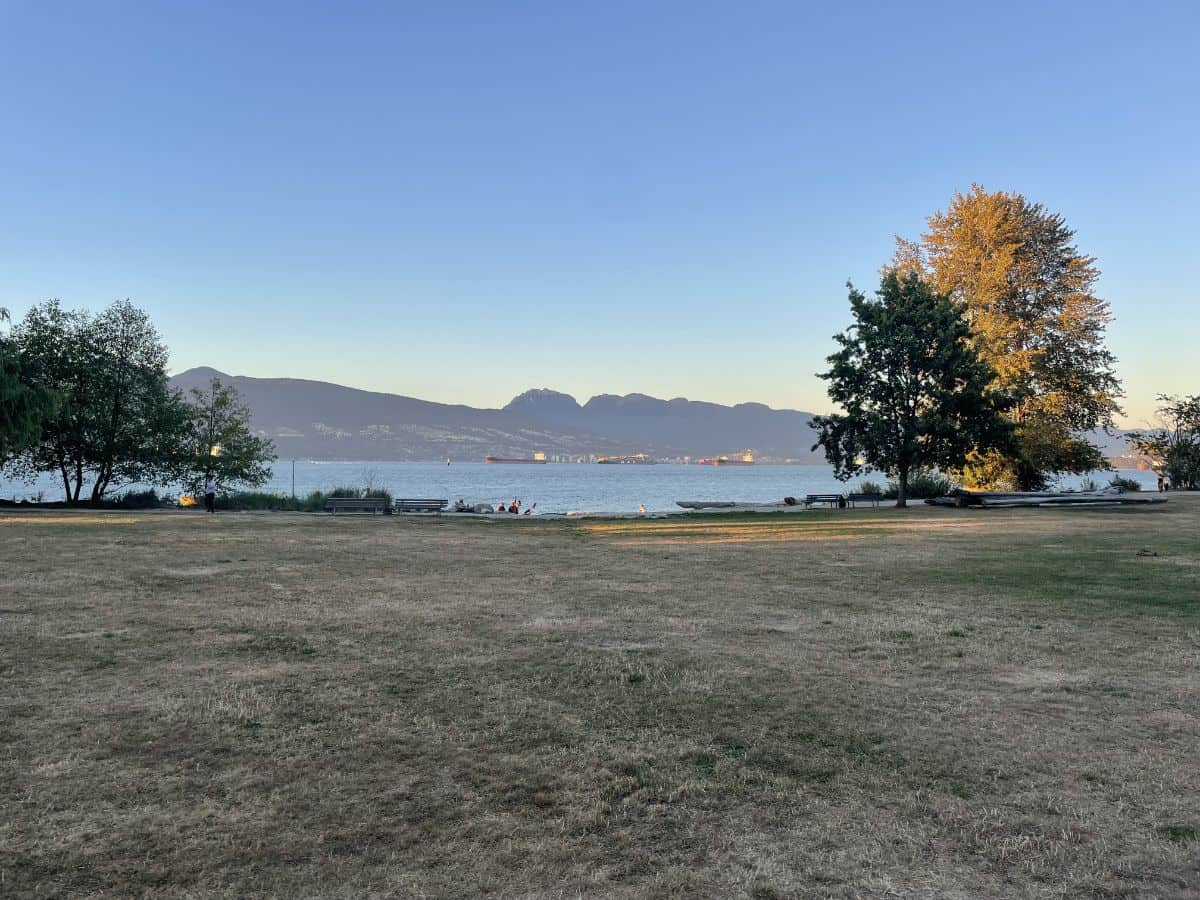 view of the ocean from the park at spanish banks in vancouver