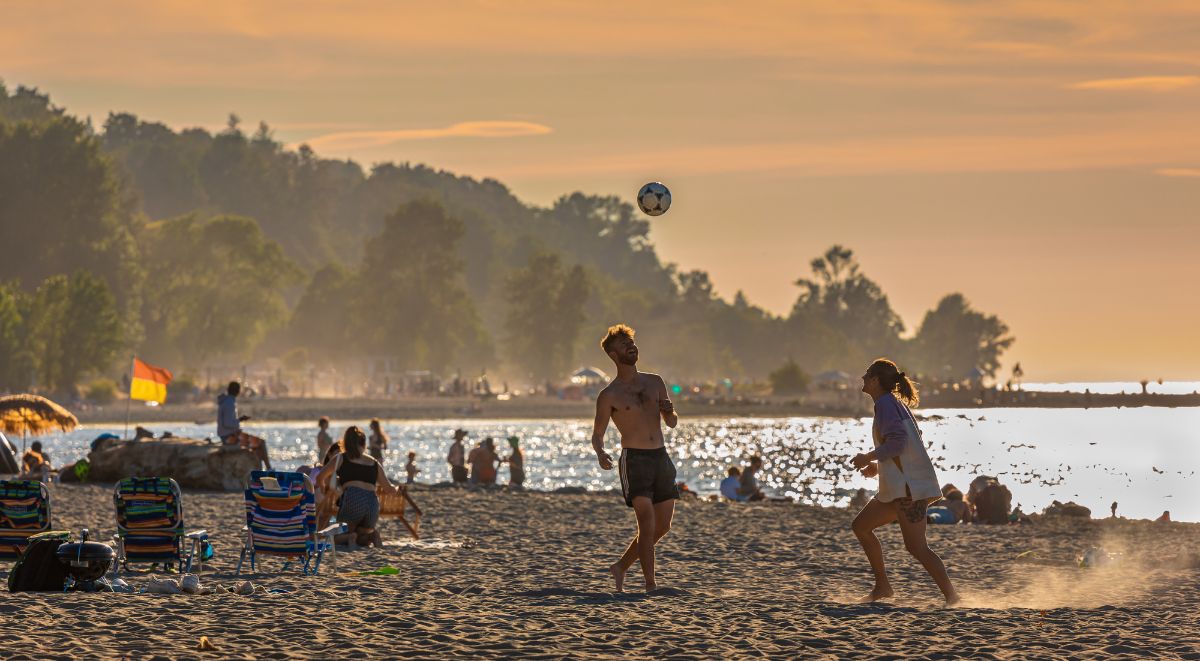 people playing soccer at spanish banks at sunset in vancouver