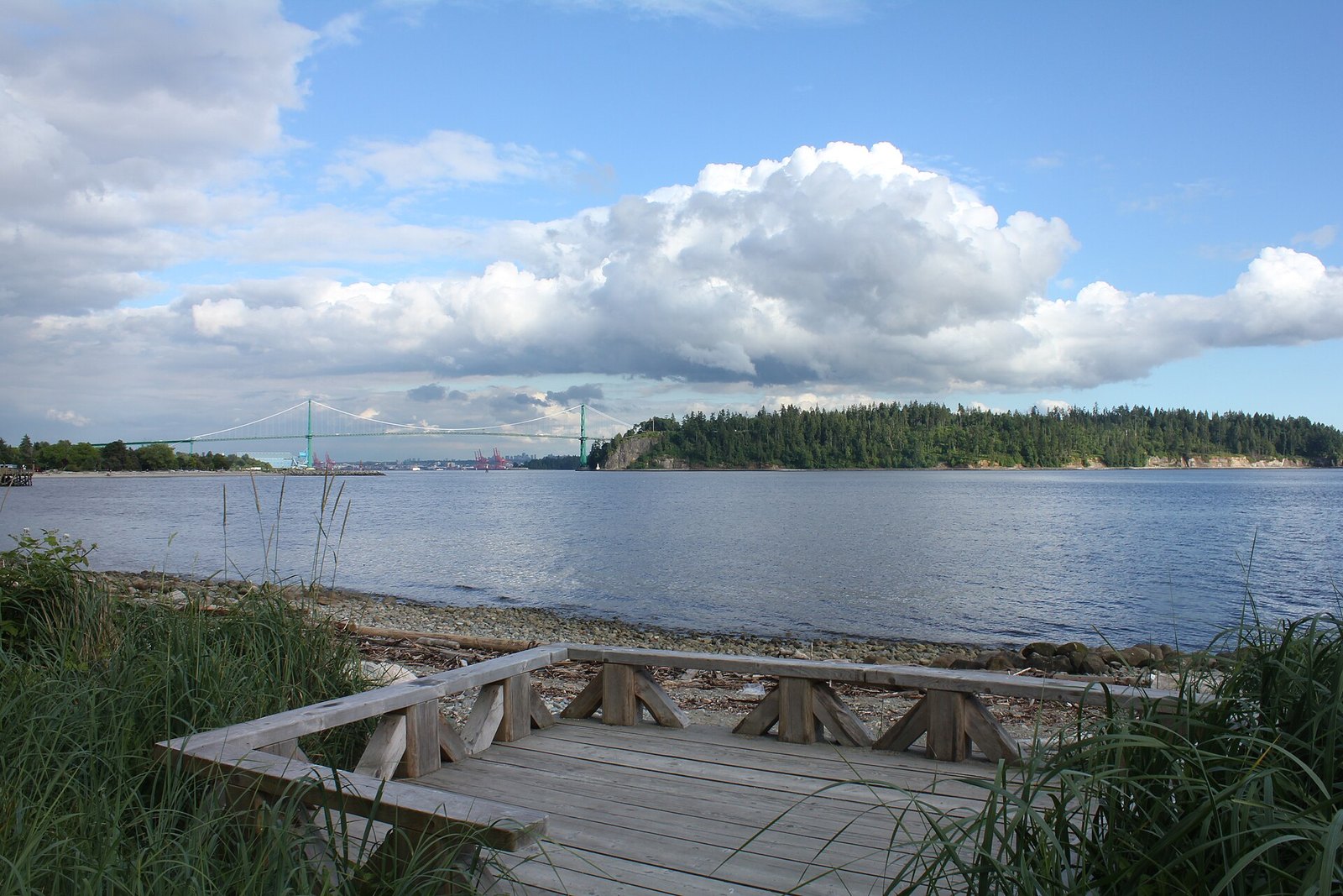 Wooden beach deck facing Lions Gate Bridge and Stanley Park