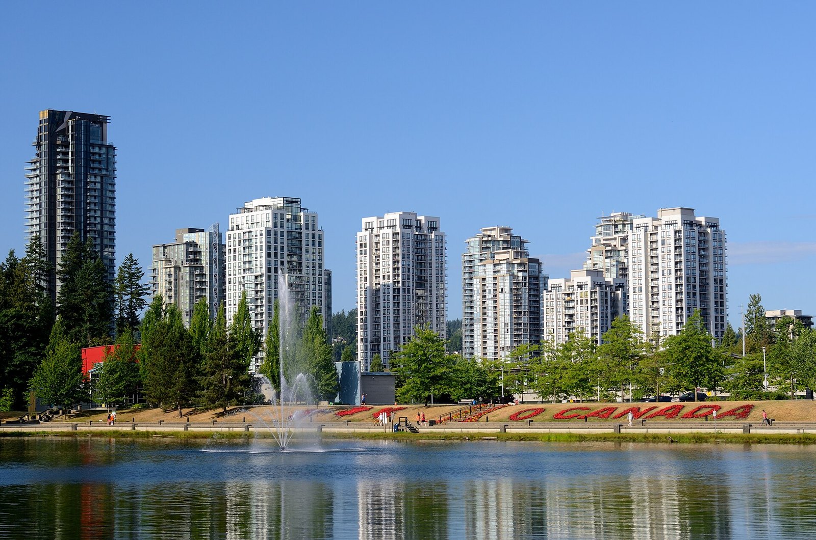 Lafarge Lake fountain and Coquitlam towers in summer