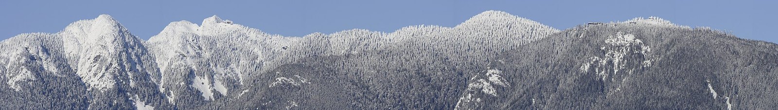 Snow-covered North Shore Mountains including Grouse summit buildings
