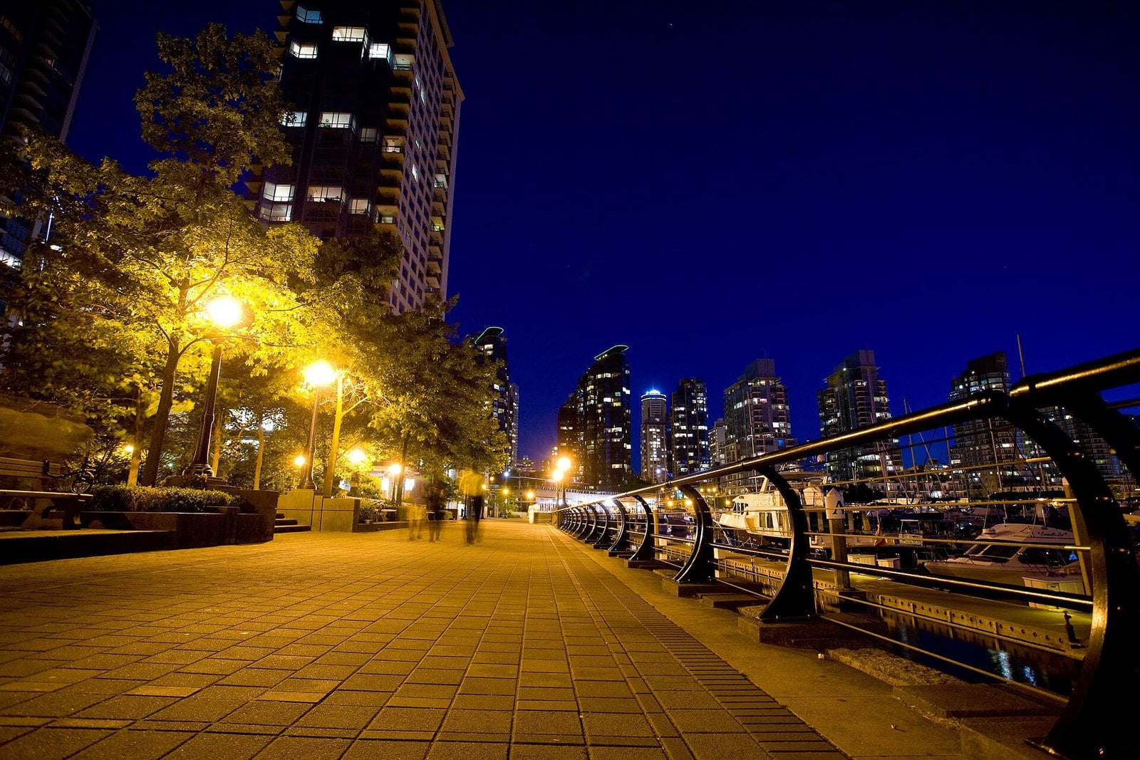 Coal Harbour seawall and marina at night with condo towers