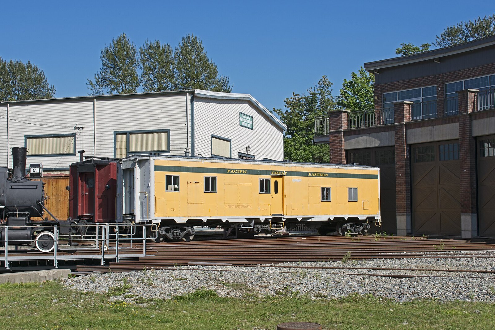 Yellow PGE baggage car at Squamish railway museum roundhouse